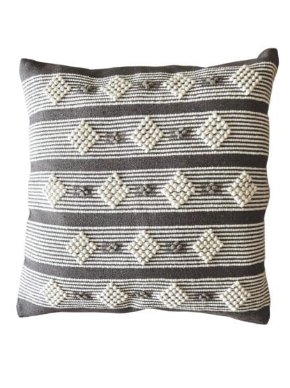 Moroccan floor pillow made with dark grey and off-white wool on a white background.