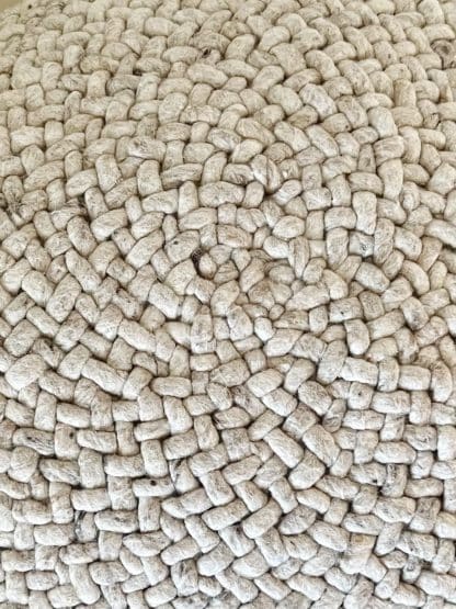 Close up of a beige Braided Pouf.