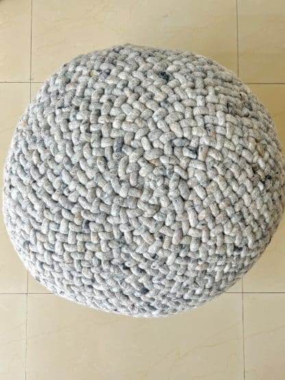 Close up shot of a heather grey Braided Pouf