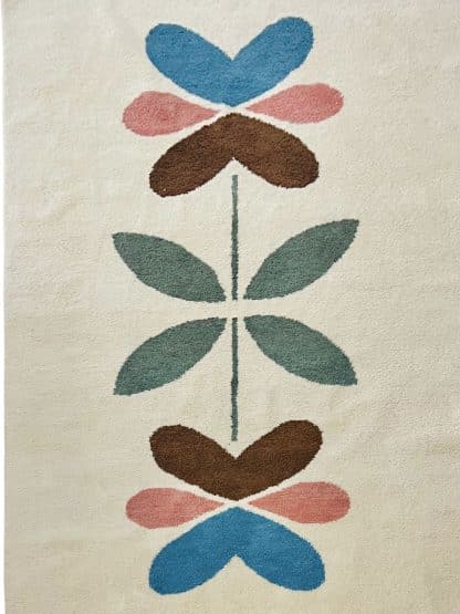 Full shot of a hand-knotted Beni Ourain style rug created with White Otter Design Co. It features a cream base with a large floral design in green, red, pink and yellow.
