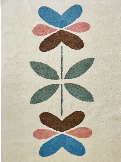 Full shot of a hand-knotted Beni Ourain style rug created with White Otter Design Co. It features a cream base with a large floral design in green, red, pink and yellow.